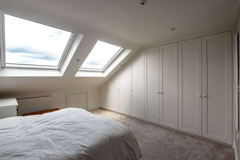 Bespoke slanted wardrobe in loft room.