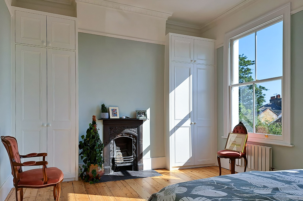 Alcove fitted wardrobes either side of fireplace