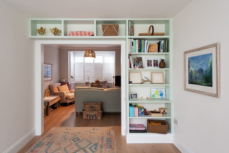 Built in shelving unit to store books and personal belongings. Designed and installed by local joiners at Bespoke Carpentry London.