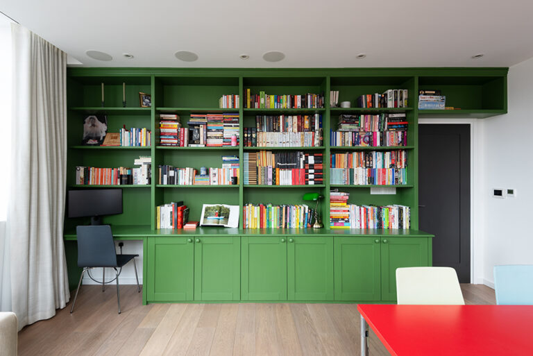 Built-in cupboard with shelving units in living room. Designed and built by Bespoke Carpentry London