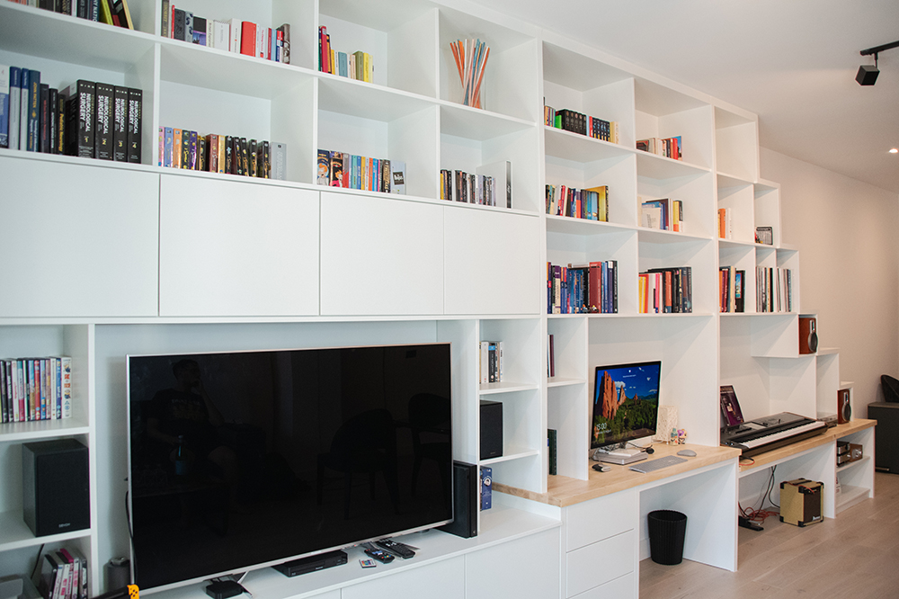 Large built-in TV unit with lots of storage space and cupboards.