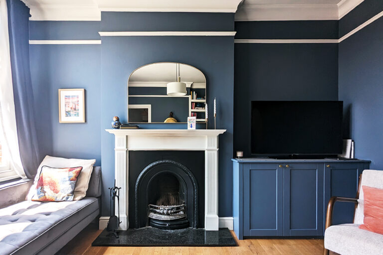 Made to measure blue alcove cupboard next to fireplace