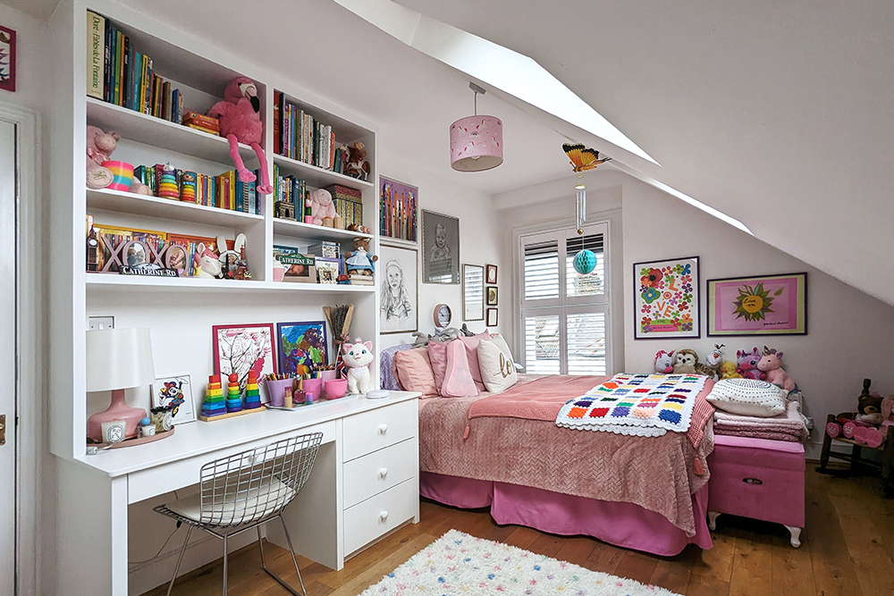 Built in child's cabinet with desk and shelving, floor to ceiling.