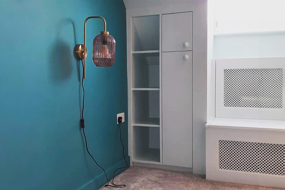 Built-in loft cupboard with shelving unit in attic.