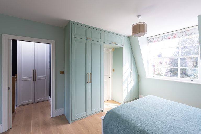 Pastel green built-in above the door wardrobe with 4 doors