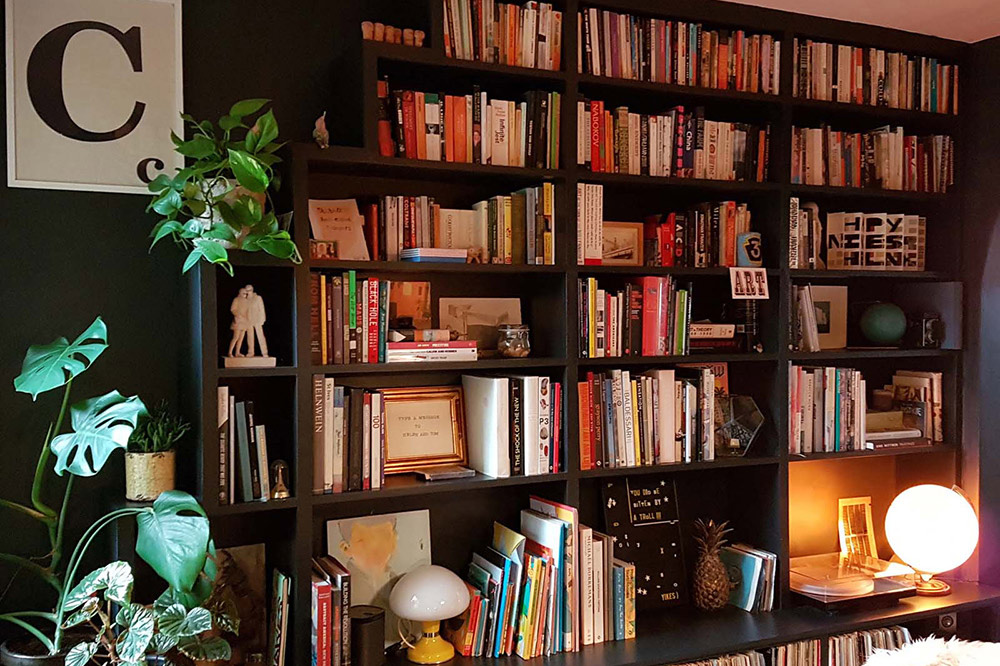 Side view of built-in wall to wall bookshelf, made with MDF and hand-painted.