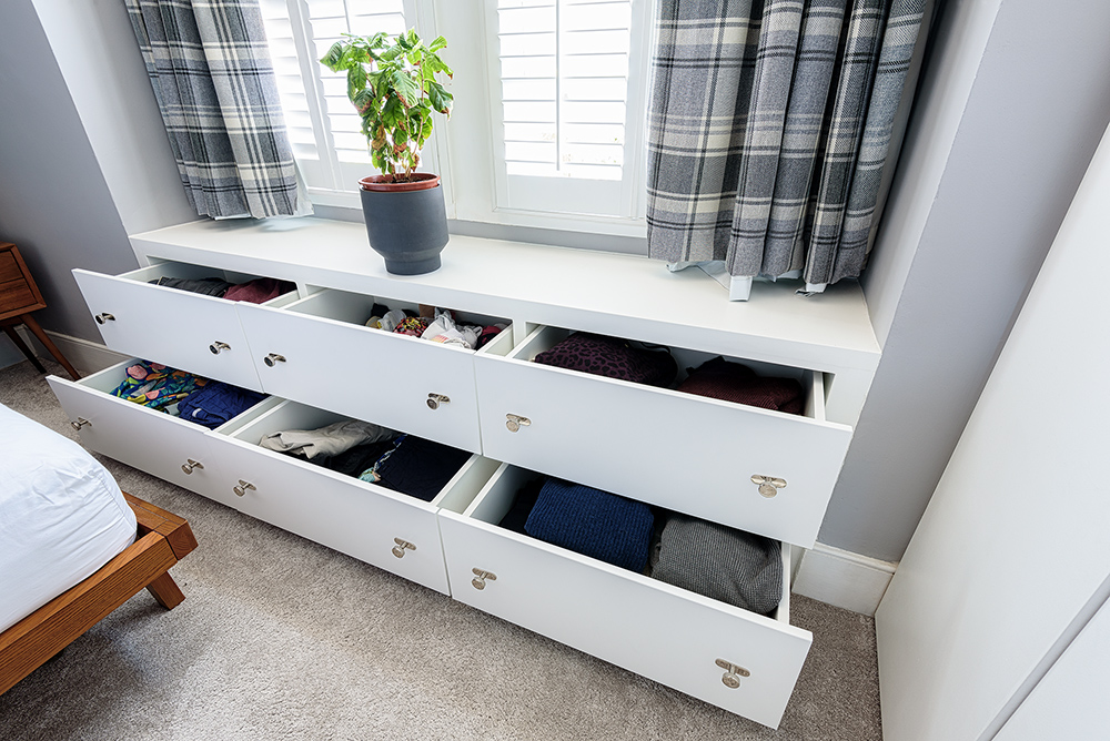 White fitted bay window seat with storage