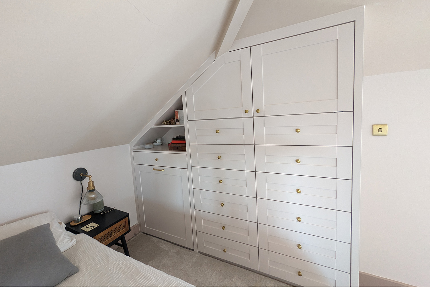 After installation picture of a built-in loft wardrobe with drawers.