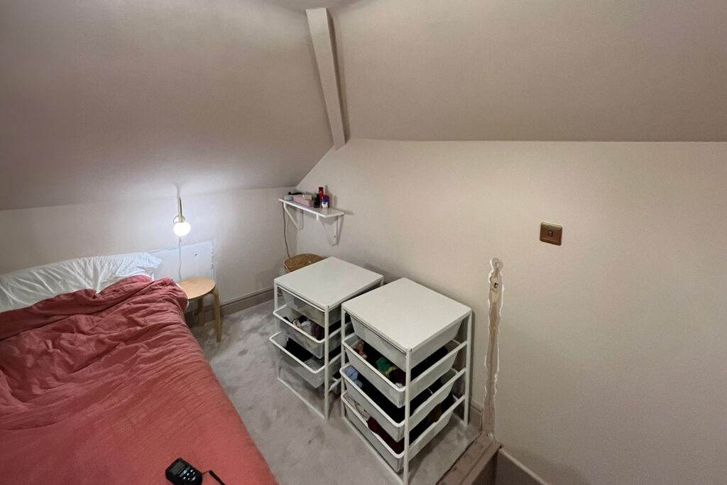 Before installation picture of a built-in loft wardrobe with drawers.