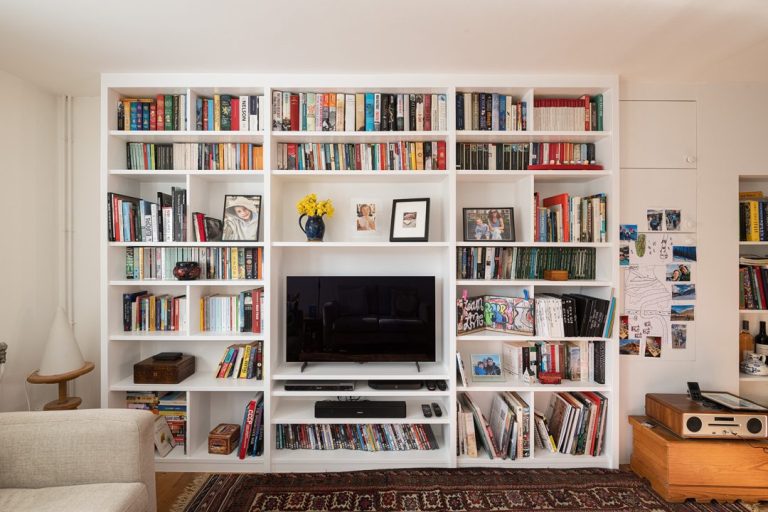 Large wall to wall built in shelving and TV Unit. Designed and installed by local carpenters at Bespoke Carpentry London.