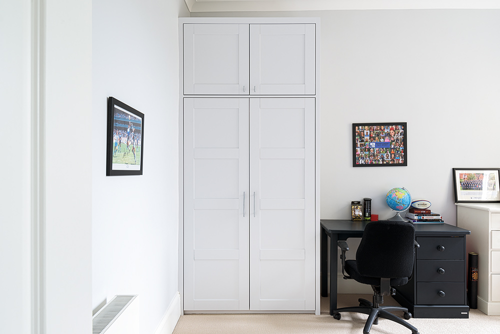 White 2 door fitted alcove wardrobe in bedroom. Made with MDF and hand-painted.