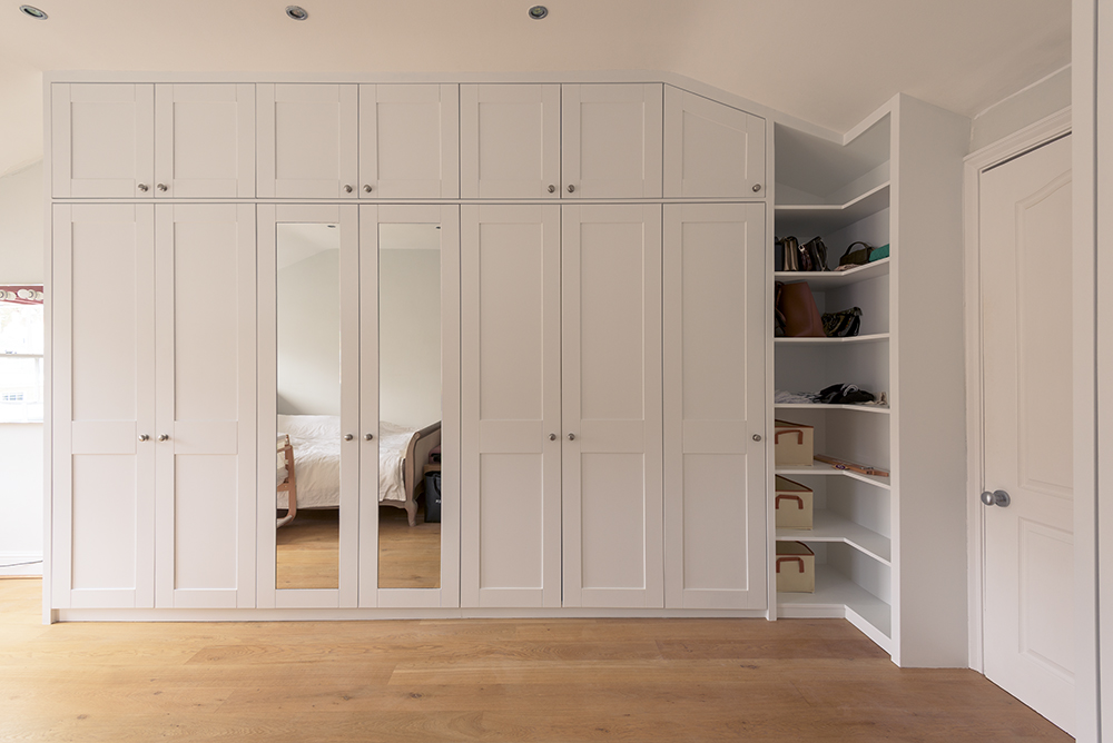 Large white built in wardrobe with corner shelving