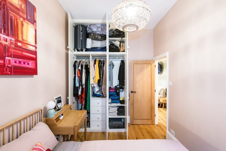 Wardrobe doors open inside of a bespoke wardrobe