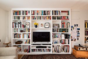 Floor to ceiling built in shelving unit and space to put TV