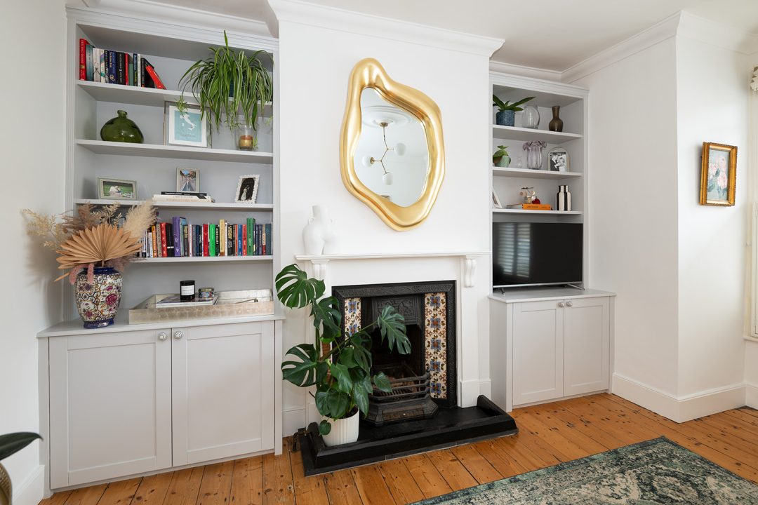 Grey built in shelving units with cupboards at the bottom of alcove spaces