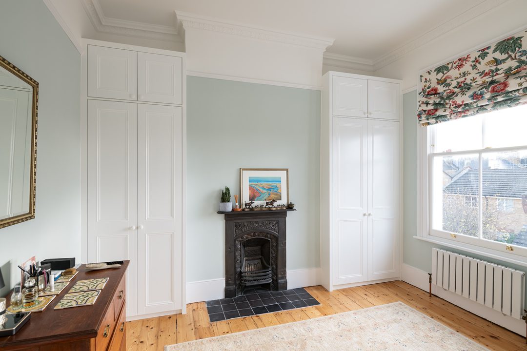 White bespoke wardrobes in alcove spaces in the bedroom