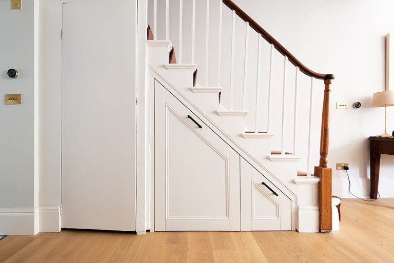 Under stairs storage in hallway with 2 drawers.