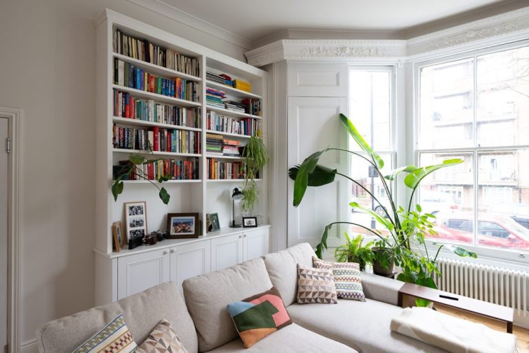 White built in shelving units with cupboards at the bottom