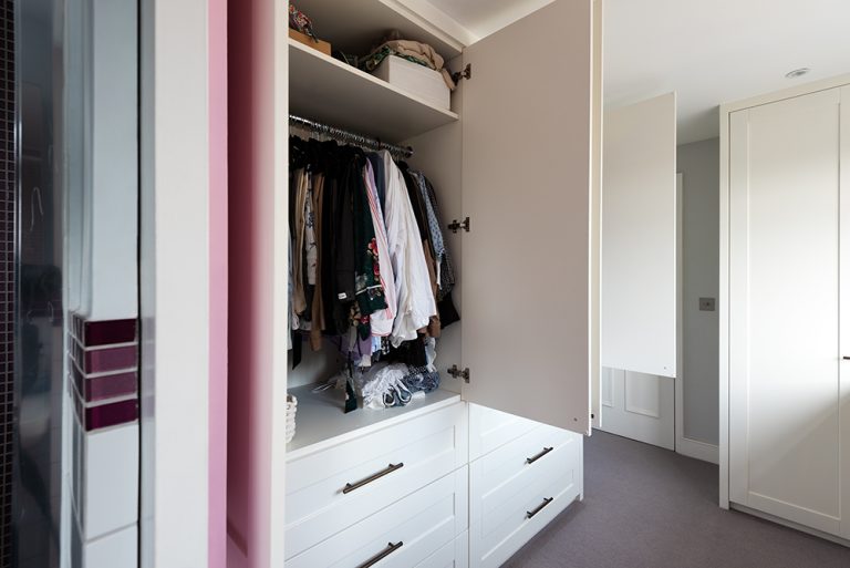 Inside view of a bespoke corner wardrobe in a hallway