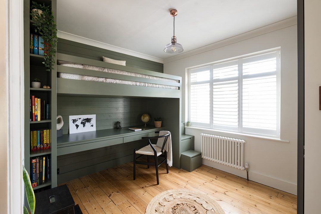 Green fitted children's cabin bed with desk