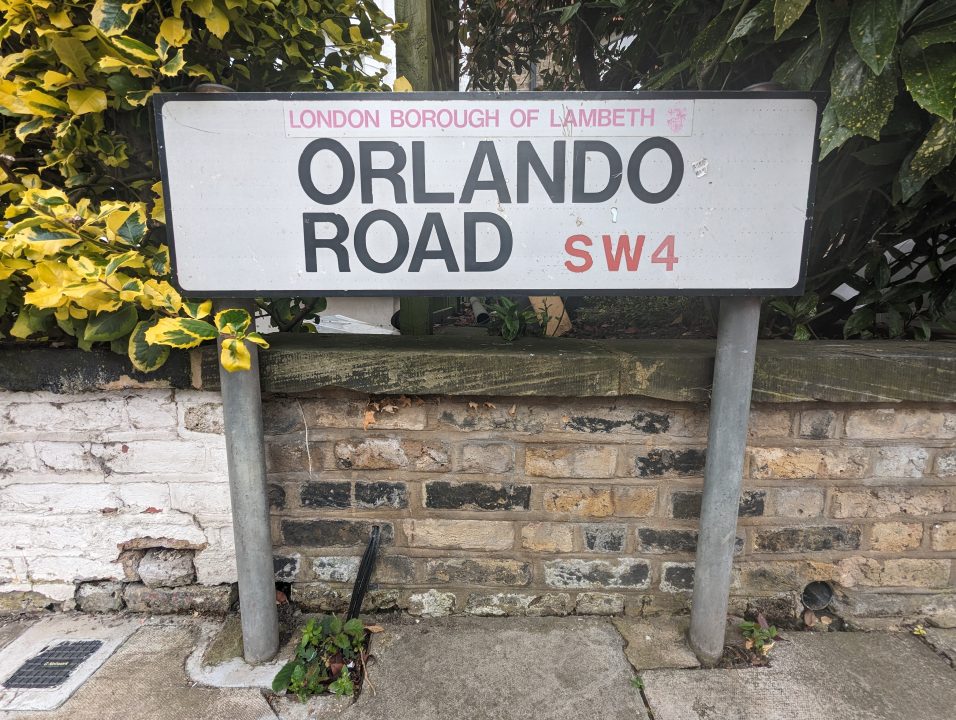 A street sign post for a road in Clapham Common called Orlando Road