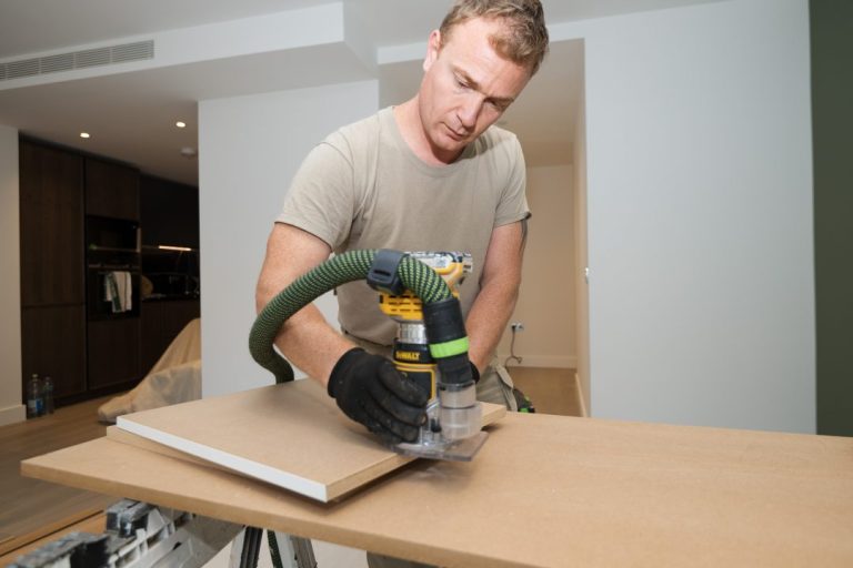 Carpenter making a TV unit in room in London