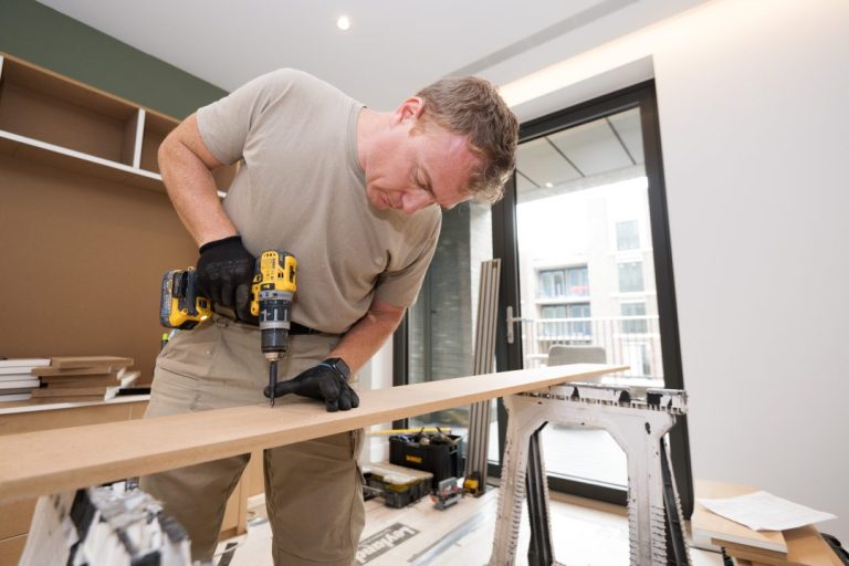 Carpenter drilling hole into wood