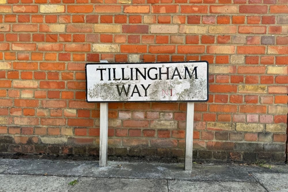 Road sign on brick wall called Tillingham Way in North London