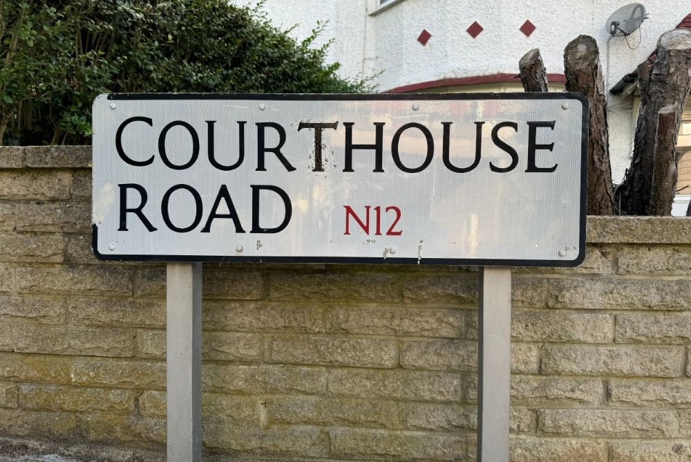 White road sign called Courthouse Road in North London