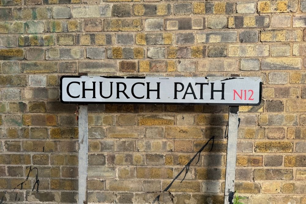 Sign against brick wall in North London