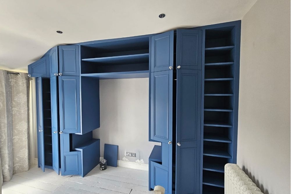 Fitted blue over bed wardrobe