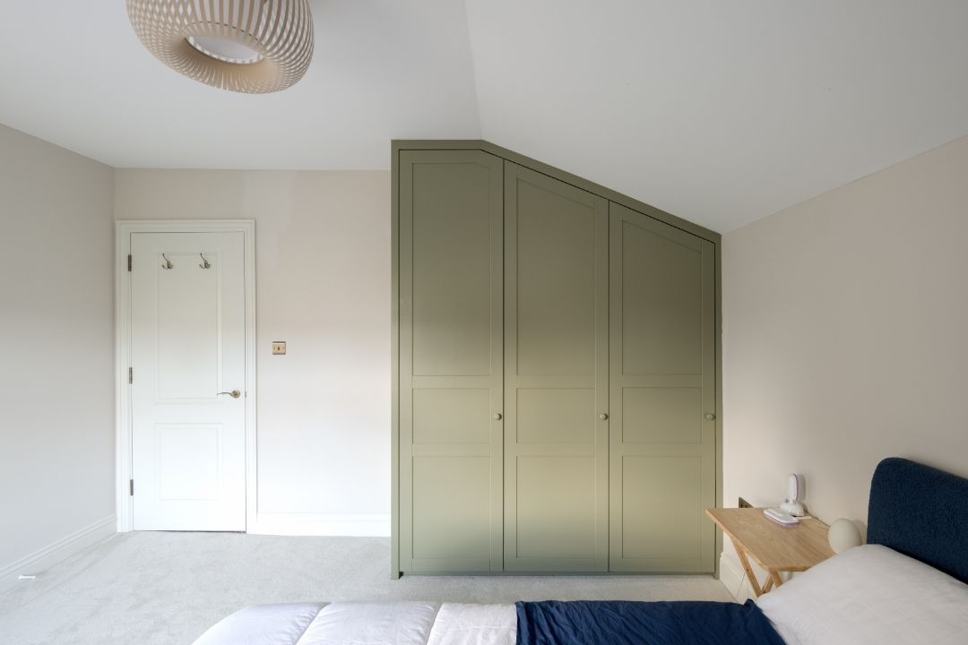 Fitted slanted wardrobe with shaker style doors