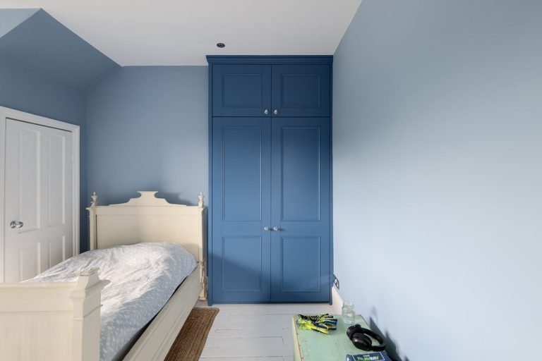 Two door fitted blue wardrobe painted in blue