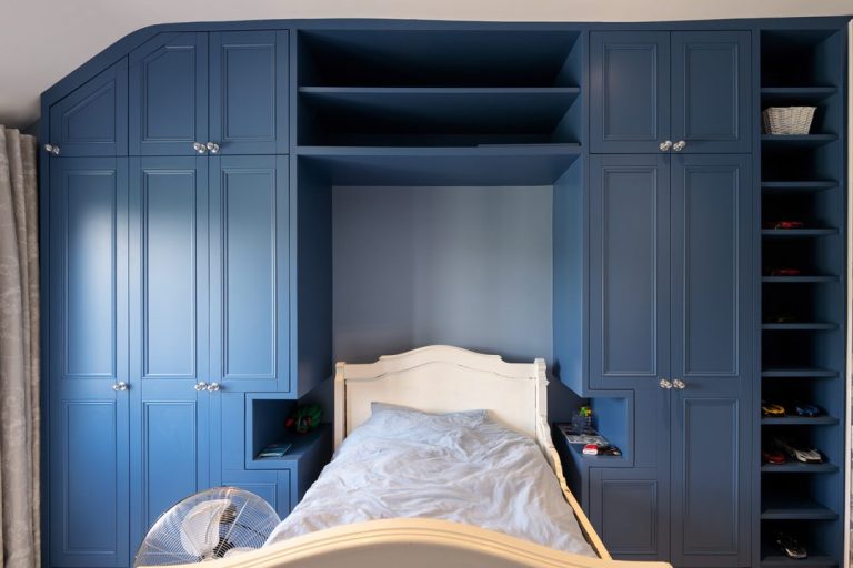 Large built in over the bed wardrobe with shelving unit