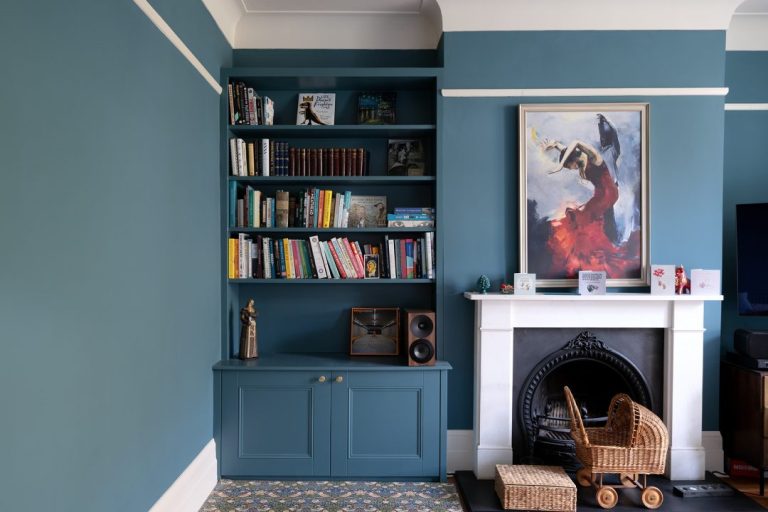 Blue alcove cabinet next to fireplace