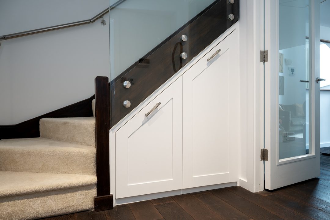 Fitted pull out drawers under the stairs