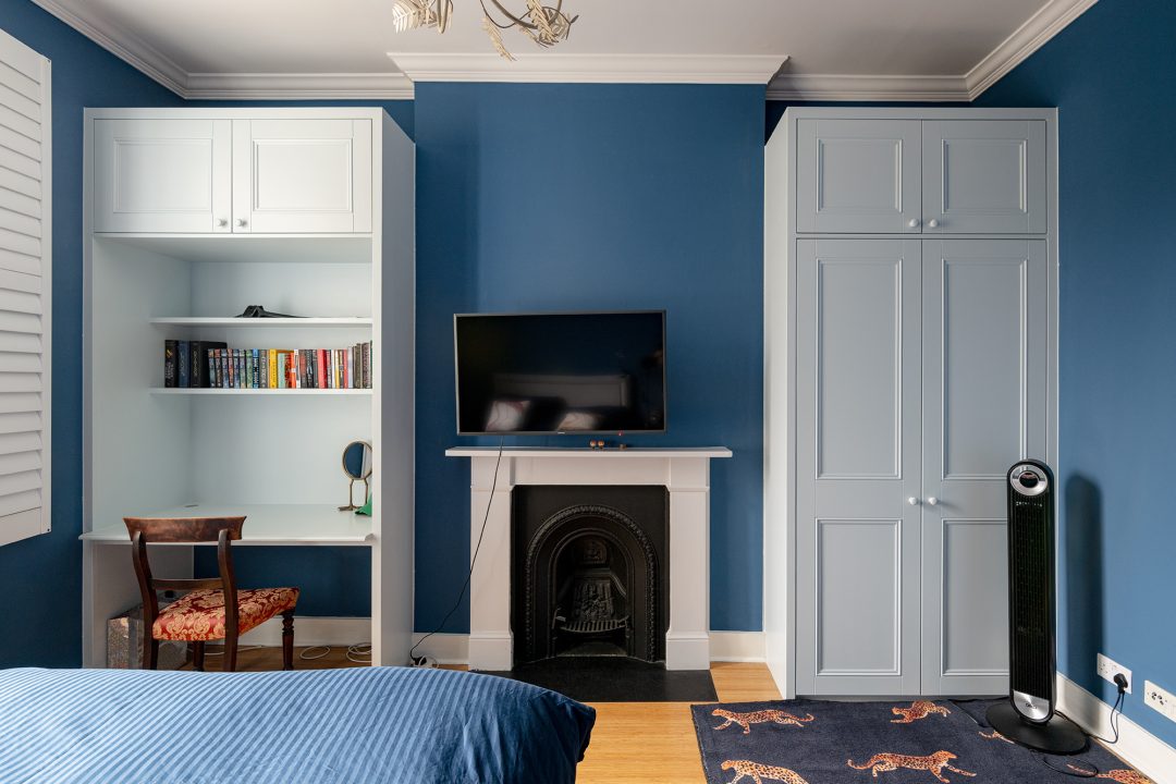 Alcove wardrobe next to chimney with desk