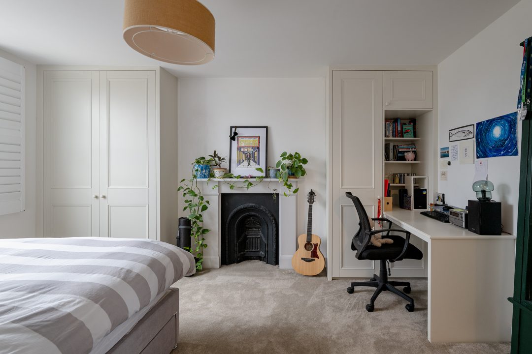 Alcove wardrobes with built in desk next to chimney