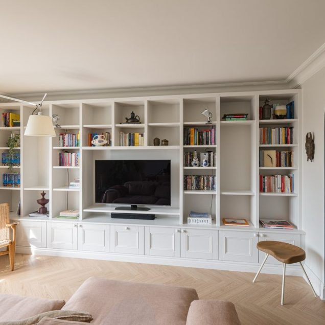 Large wall to wall built in TV unit with storage cupboards and shelving unit.